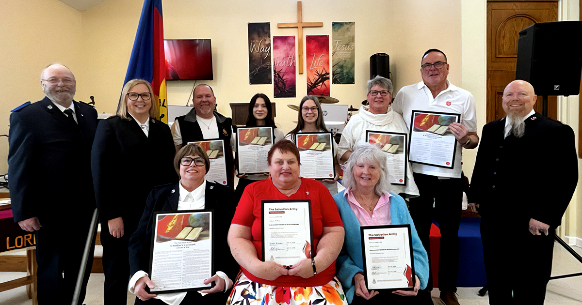 A group of people smiling and holding certificates